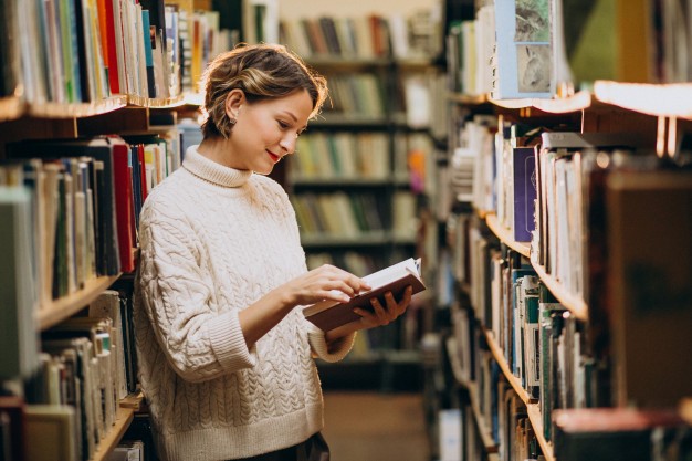woman reading a romance novel in a bookstore