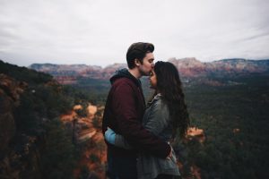 a-couple-embracing-against-a-backdrop-of-a-gorgeous-valley